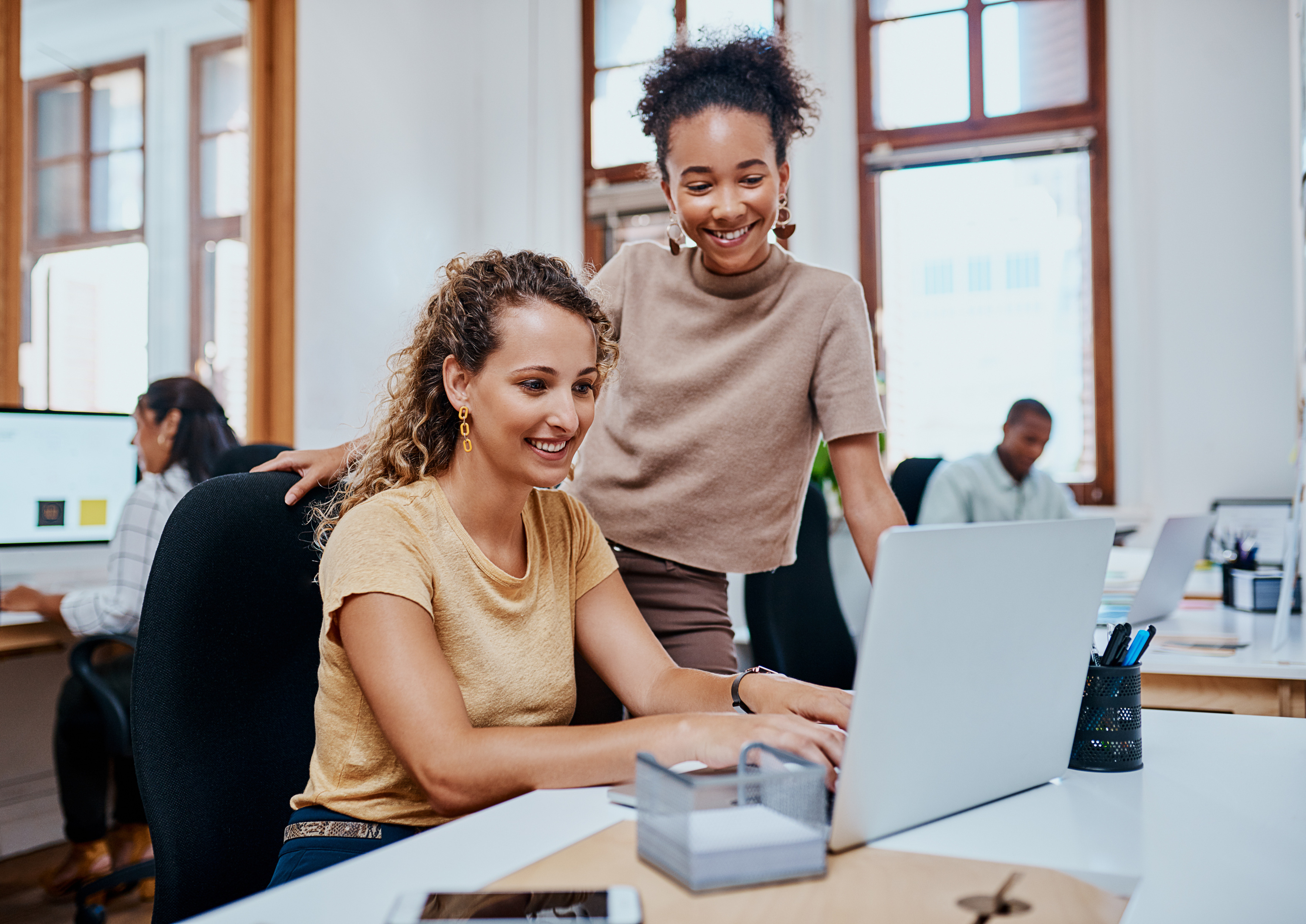 Woman on a computer working with a coworker